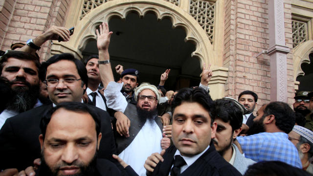 Hafiz Saeed, center, reacts to supporters as he walks out of court after he was ordered released from house arrest in Lahore, Pakistan, Nov. 22, 2017. 