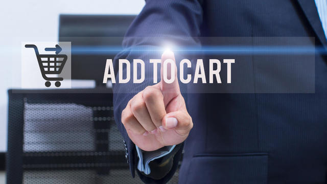 business, technology and internet concept - businessman pressing add to cart button on virtual screens 