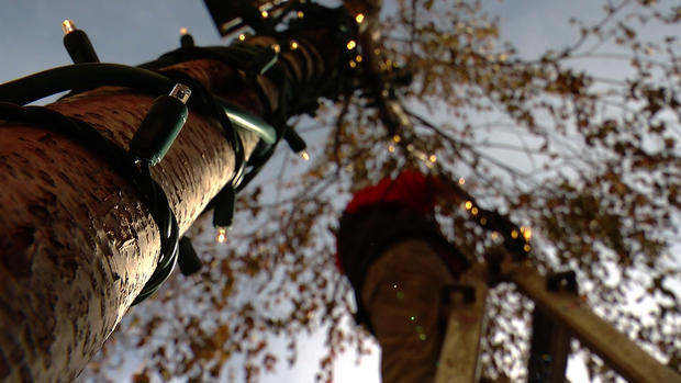 Rick Giesler hanging Christmas lights 