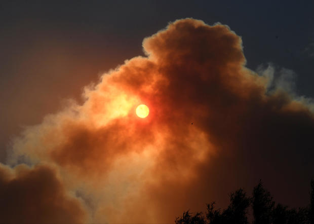 The morning sun is block by the thick smoke from an early-morning Creek Fire that broke out in the Kagel Canyon area in the San Fernando Valley north of Los Angeles in Sylmar 