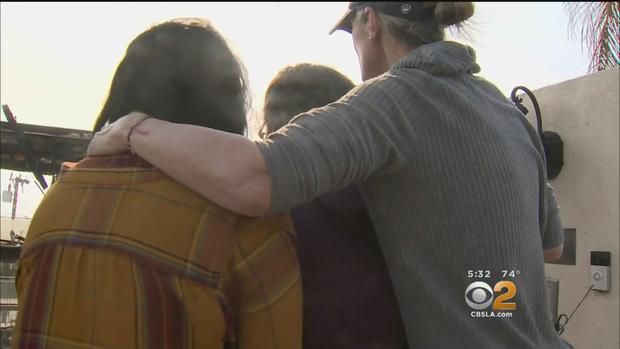 Vanessa Zeigert-Joyce comforting her children as they look at what remained of their home in La Conchita. 
