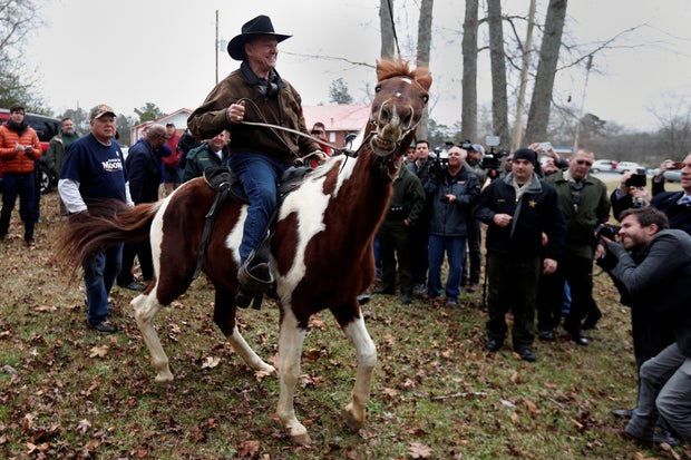 Republican Senate candidate Roy Moore departs on horseback after he cast his ballot in Gallant, Alabama
