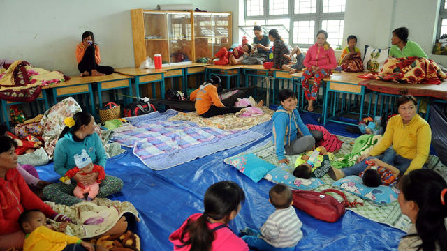 Vietnamese residents are seen at an evacuation center before Tempin storm hits the land in Ho Chi Minh city 