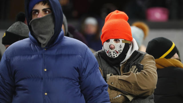 People walk through Times Square as a cold weather front hit the region in Manhattan, New York 