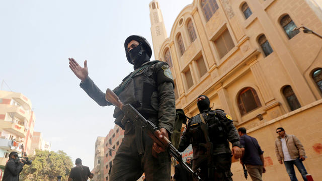 Security forces stand guard at the site of attack on Mar Mina church in Helwan district on the outskirts of Cairo 