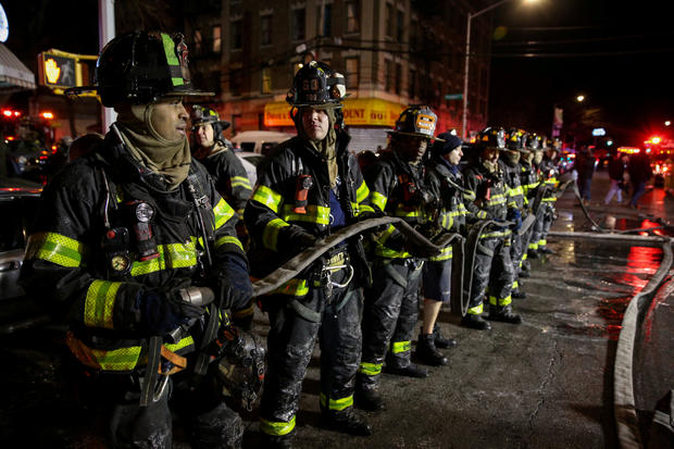 FDNY personnel work on the scene of an apartment fire in New York 