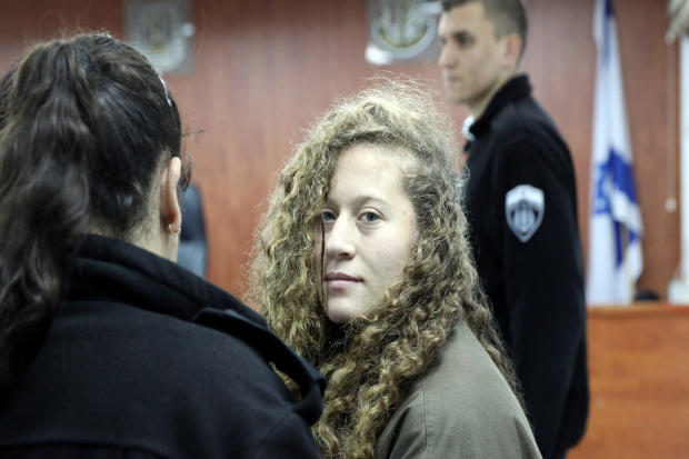 Palestinian teen Ahed Tamimi enters a military courtroom escorted by Israeli Prison Service personnel at Ofer Prison, near the West Bank city of Ramallah, Jan. 1, 2018. 