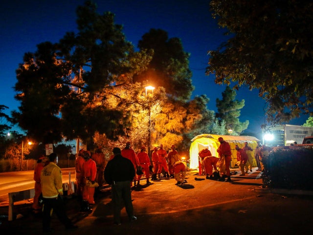 California Department of Corrections and Rehabilitation prisoners exit a shower tent used by rescue workers after a mudslide in Santa Barbara