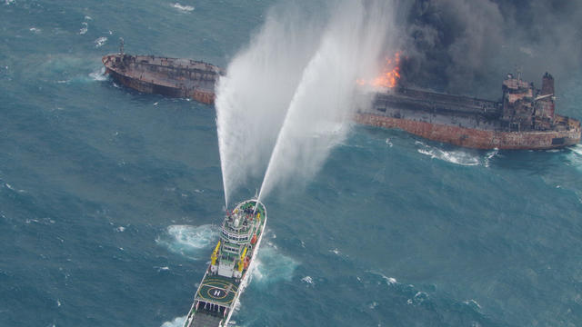 A rescue ship works to extinguish the fire on the stricken Iranian oil tanker Sanchi in the East China Sea 