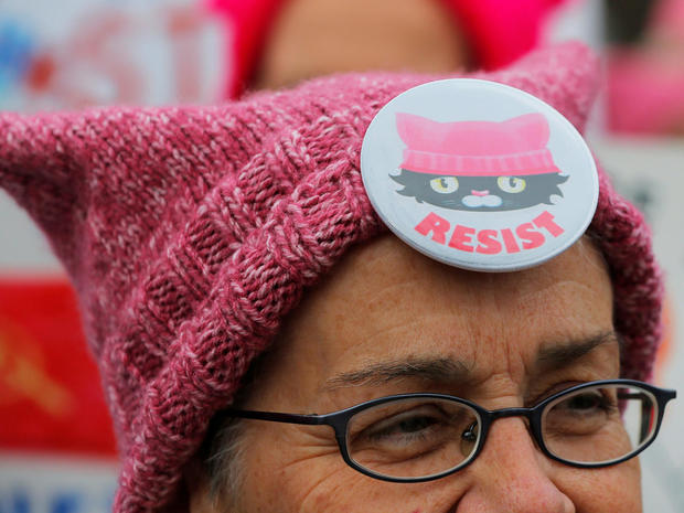 A woman wearing a pink "pussyhat" attends the local second annual Women's March in Cambridge 