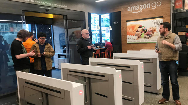 Shoppers enter the Amazon Go store located in Amazon's "Day 1" office building in Seattle 