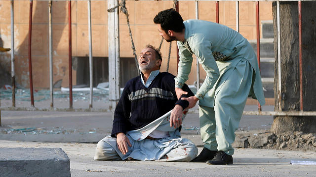 Man reacts after hearing his son was killed during a car bomb attack in Kabul 