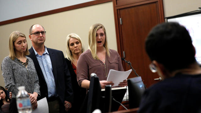 Victims and former gymnasts Maddie and Kara Johnson speak alongside their parents Brad and Kelly Johnson at the sentencing hearing for Larry Nassar, in Lansing 