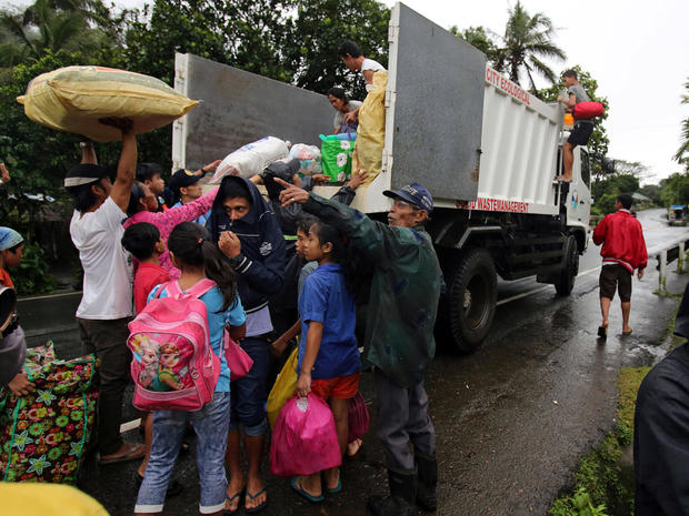 Residents with their belongings board a truck as they prepare to depart to the evacuation center after Mayon volcano spews ashes, in Ligao city, Albay province 