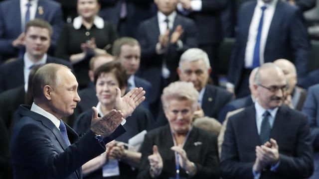 Russian President Vladimir Putin gestures as he attends a meeting with his confidants ahead of the upcoming presidential election in Moscow 