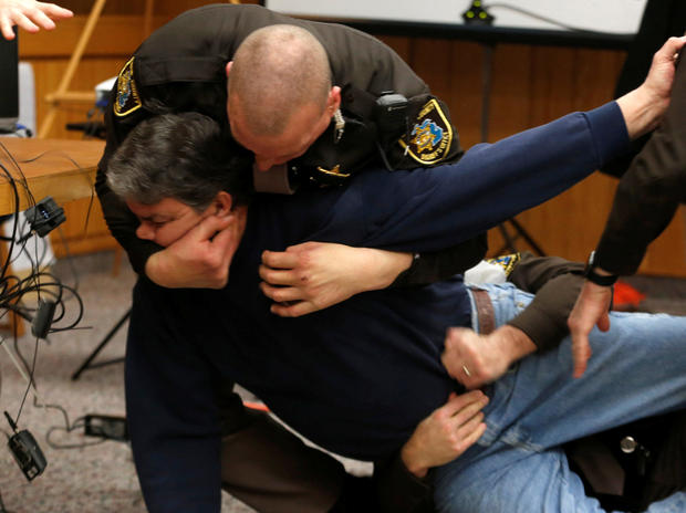 Eaton County sheriff's deputies restrain Randall Margraves after he lunged at Larry Nassar, a former USA Gymnastics team doctor who pleaded guilty in November 2017 to sexual assault charges, during victim statements in his final sentencing hearing in Eato 