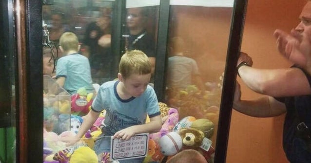 Boy gets suck in claw machine game trying to get a stuffed animal - CBS News