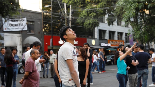 People react during a tremor in Mexico City 