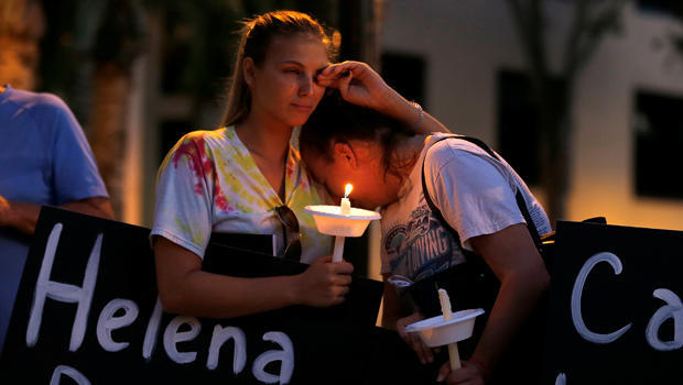 Tori Stetzer and Taylor Miler, both of Parkland, react during a candlelight vigil for victims of the shooting in Parkland, Florida at Florida Atlantic University in Boca Raton 