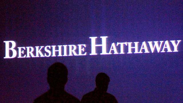 FILE PHOTO: Berkshire Hathaway shareholders walking by a video screen at the company's annual meeting in Omaha 