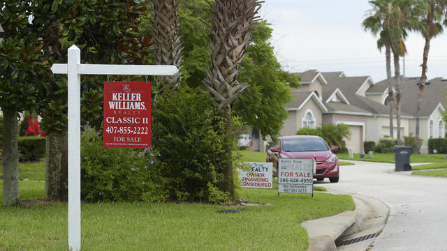 For Sale signs stand in front of houses in a neighborhood where many British people have purchased homes 