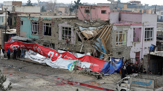 People gather at the site of a suicide bomb attack in Kabul 