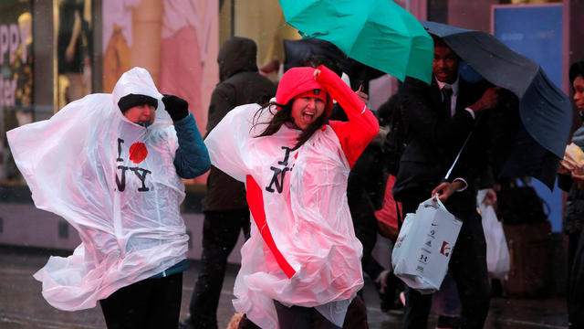 People struggle against strong wind while waiting to cross 42nd Street in the Times Square district during a winter nor'easter in New York City, U.S. 