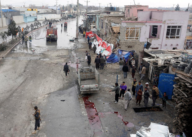 Afghan police inspect the site of a suicide bomb attack in Kabul 