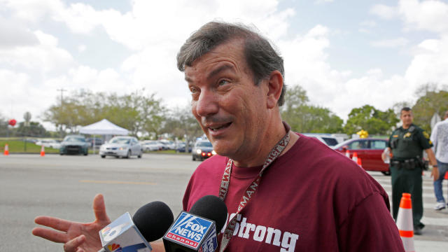 Mathematics teacher Jim Gard speaks with reporters at Marjory Stoneman Douglas High School in Parkland, Florida, Feb. 23, 2018. 