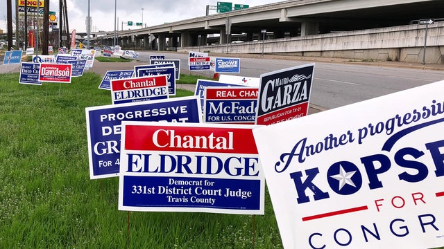 Political campaign signs stand outside a polling station in Austin 