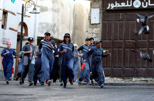 Women run during an event marking International Women's Day in Old Jeddah 