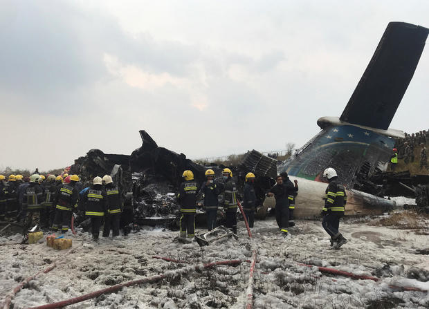 Wreckage of an airplane is pictured as rescue workers operate at Kathmandu airport 