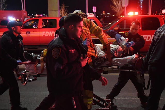Paramedics and members of the NYFD perform CPR on a victim of a helicopter that crashed into the East River in New York 