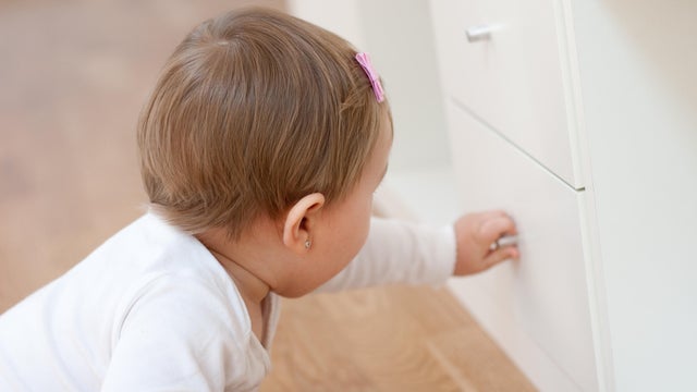 Baby opening a drawer 