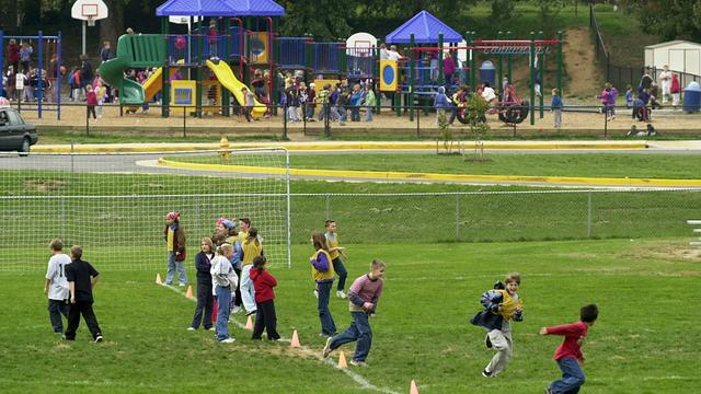 Students play on the soccer field and playground f 