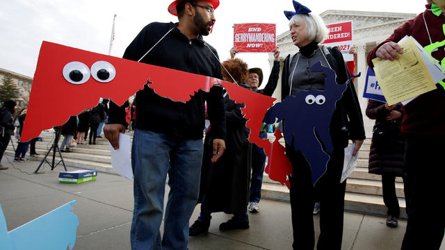 Demonstrators rally in front of the Supreme court before oral arguments on Benisek v. Lamone in Washington 