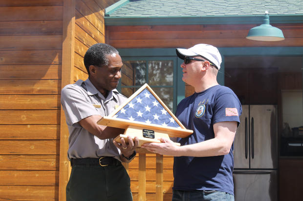 C. Spencer receives US flag from CMDCM Luby copy 