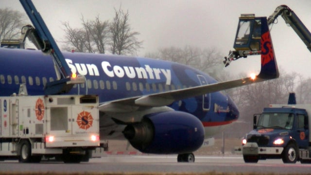 A Sun Country Airlines is deiced during cold weather. 