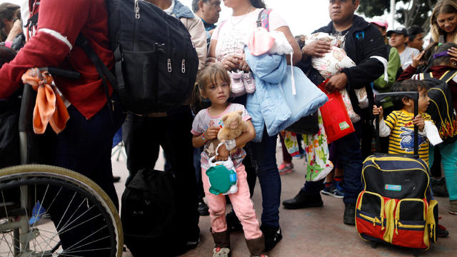 Members of a caravan of migrants from Central America wait to enter the United States border and customs facility in Tijuana 