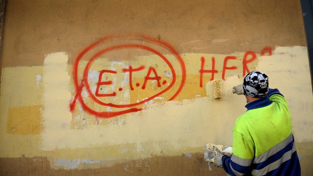 FILE PHOTO: A municipal worker paints over graffiti reading "ETA, The People Are With You" in Guernica October 21, 2011, the day after Basque separatist group ETA announced definitive cessation of armed activity in Guernica 
