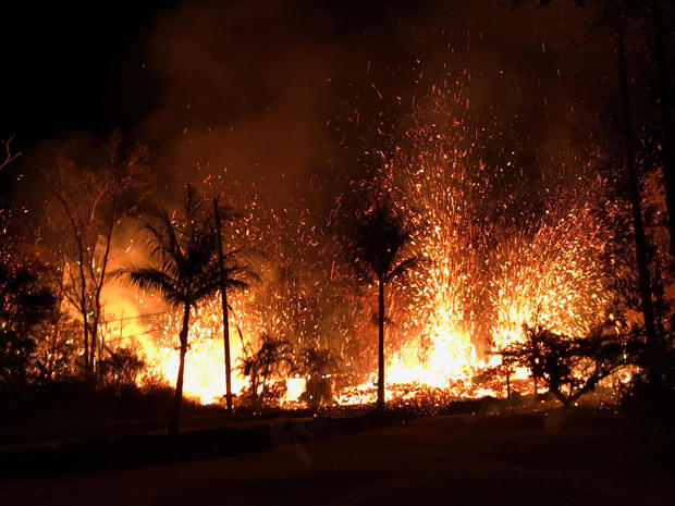 Handout photo of a new fissure spraying lava fountains as high as about 230 feet (70 m), according to United States Geological Survey, is shown from Luana Street in Leilani Estates subdivision on Kilauea Volcano's lower East Rift Zone in Hawaii 
