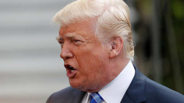 U.S. President Donald Trump speaks to the news media before boarding Marine One to depart for travel to Texas from the South Lawn of the White House 