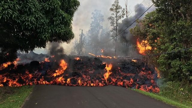 A lava flow from the Kilauea volcano, moves on a street in Leilani Estates in Hawaii 