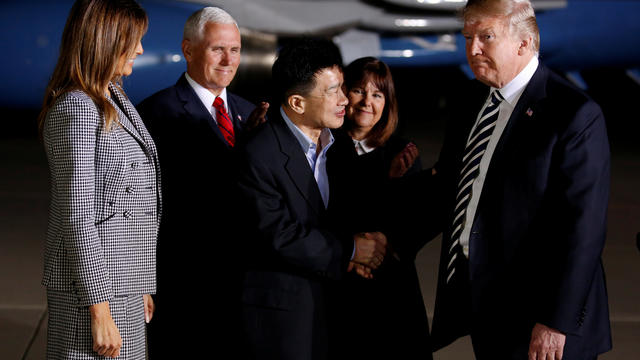 U.S.President Donald Trump shakes hands with one of the three Americans formerly held hostage in North Korea upon their arrival at Joint Base Andrews 