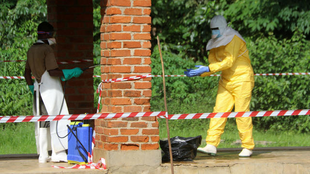 A health worker is sprayed with chlorine after visiting the isolation ward at Bikoro hospital, which received a new suspected Ebola case, in Bikoro 