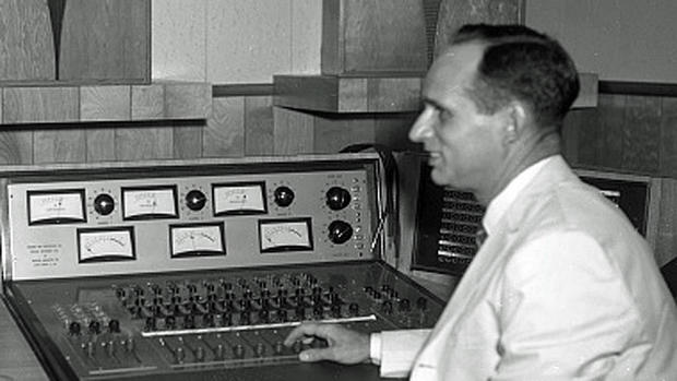Recording Engineer Glenn Snoddy looking at three-track mixing console, Bradley Studio,, Nashville.Shot between 1960 and 1962 
