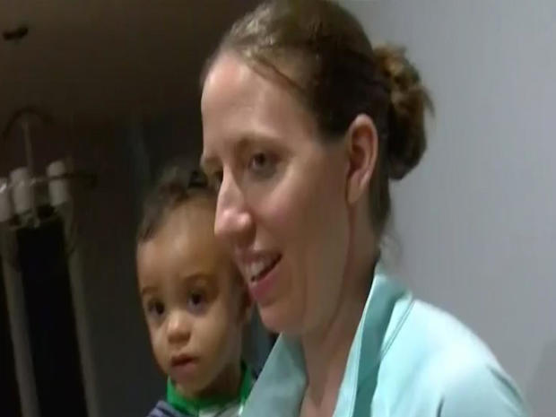 Lindsay Gottlieb, head coach of the University of California women's basketball team, holds her 1-year-old son during an interview with CBS San Francisco station KPIX-TV on May 28, 2018. 