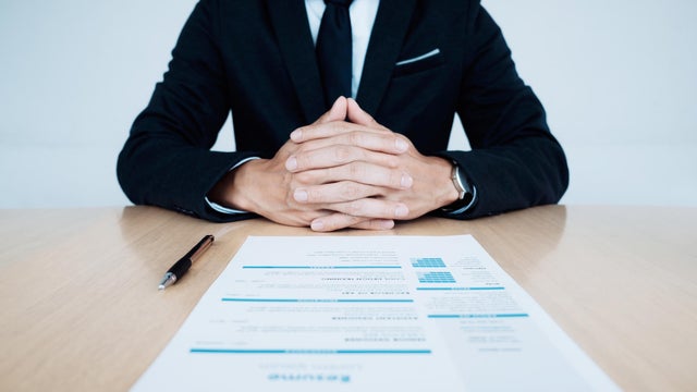 Business Job interview. HR and resume of applicant on table. 