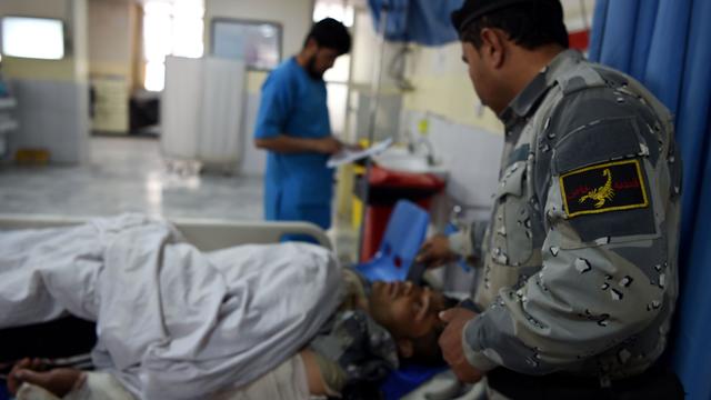 Afghan policemen stand guard amid an attack and gunfire in Kabul 