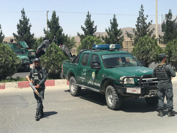Afghan policemen stand guard amid an attack and gunfire in Kabul 
